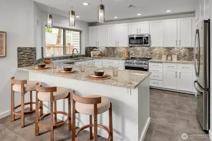 Warm, inviting...NEW(er) SS appliances, custom tile touches, new lighting.....new, fresh and clean interior paint! This kitchen has a walk-in pantry, ideal island w/counter seating + lots of storage too! Large, open, bright and beautiful in every way is this home in the desirable community of Walnut Hills in Redmond.