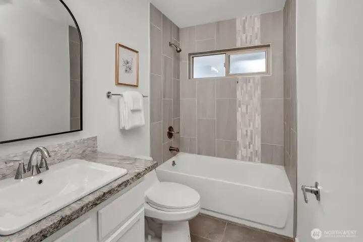 2nd/Guest bath is nicely remodeled to reflect the same quality as the other rooms of this wonderful home. Custom tile, lighting, fixtures....and paint! Move-in ready in every way!