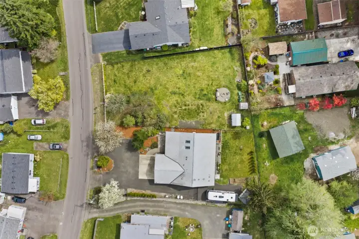Enjoy the double lot, or sell it.  Water/Power in the street.