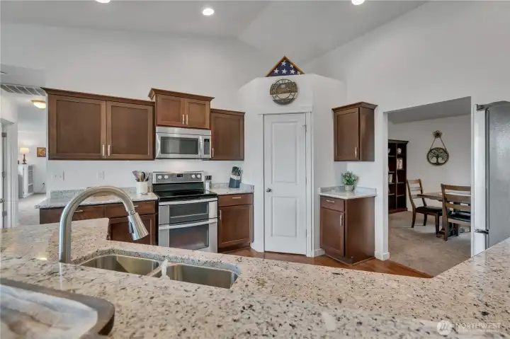 Granite Bar and Kitchen countertops!  Corner pantry, double stainless kitchen sink.