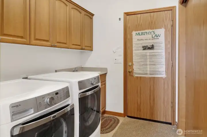 Laundry room with sink and off garrage.