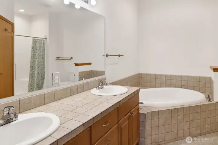 Primary bath double vanity, soaker tub and separate shower.