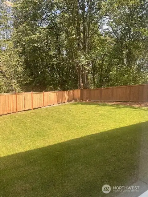 HUGE fenced yard backed to private greenspace