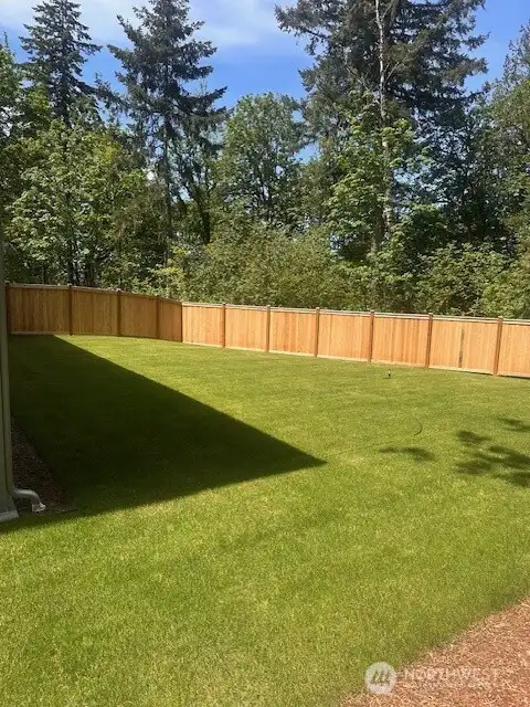 HUGE fenced yard backed to private greenspace