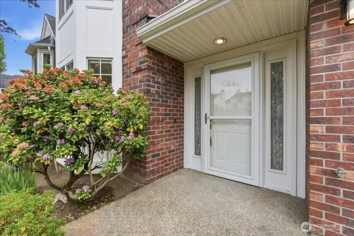 Level front entry with brick accent.