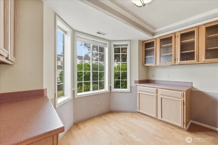 Kitchen eating space with bay window for extra light.