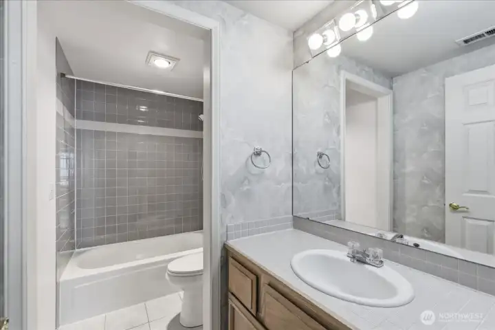 Full bath has access to the family room as well as the living room for guests.