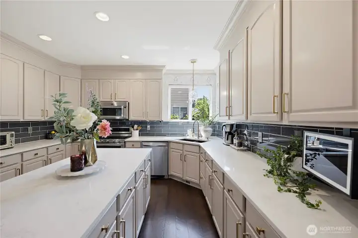 Updated kitchen with the perfect shade of cabinetry, stretched to the ceiling and crowned