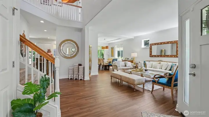 Dramatic entryway with a double wide staircase and statement chandelier.