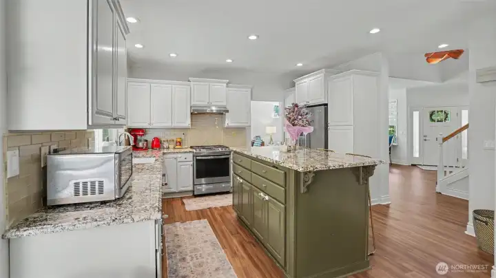 Another view of the kitchen, featuring a tall island!
