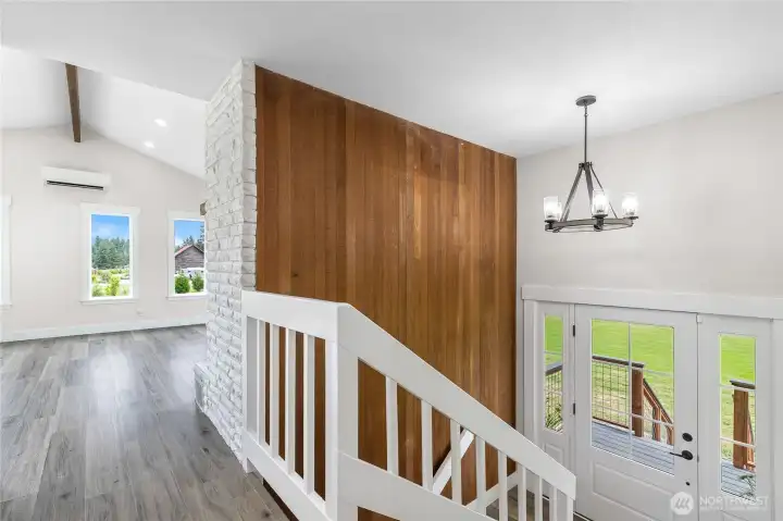 Beautiful entry with wood paneling highlights the stair case
