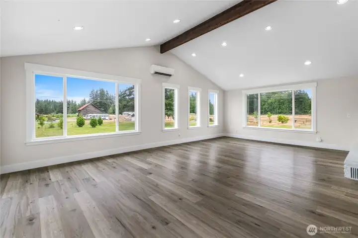 Flooded with natural light from numerous windows and the wood beam adds character to this room