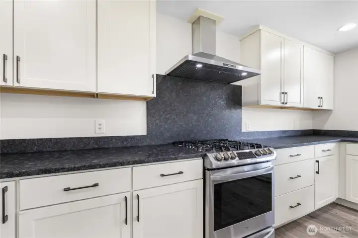 All appliances are new in 2021, including this propane range and hood fan