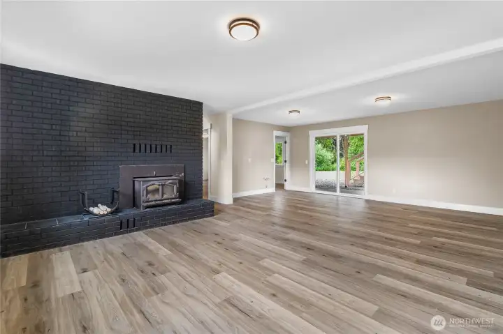 Ground floor huge family room with wood burning fireplace insert and a slider into the yard.