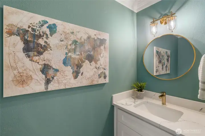 Main floor powder room with updated vanity, lights and mirror.