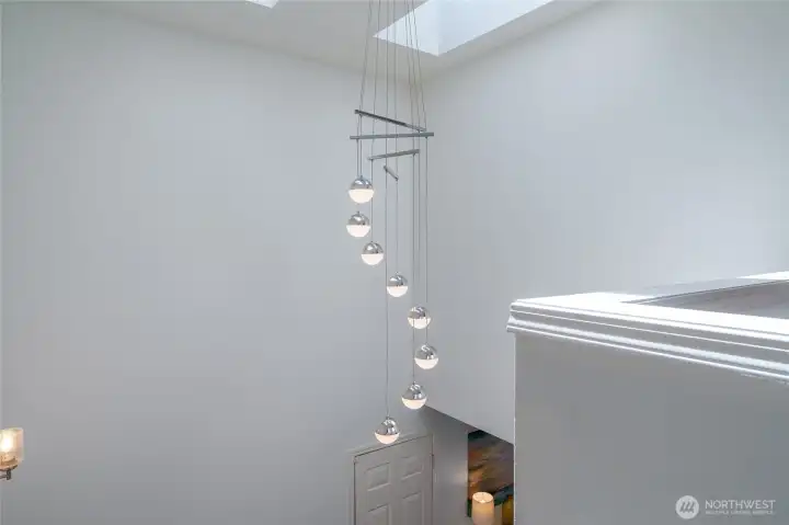 Stairwell with two skylights and abundant lighting.