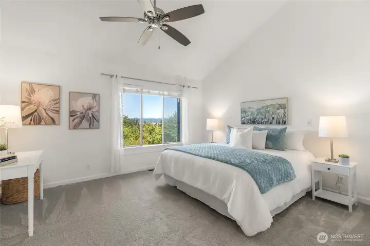 Upper primary suite offers views, vaulted ceilings and is a quiet reprise.
