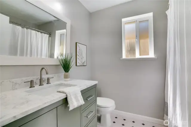Full guest bathroom is newly modernized - sink, fanity, lighting and floor all newly installed.