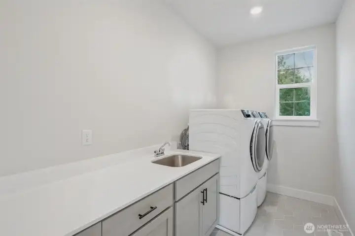 Now wouldn't doing laundry in this room be fun?  Cabinets, sink and washer and dryer included!