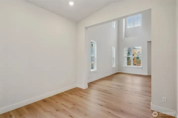 Dining room to living room. Tall, clear-story at living room with massive size windows.