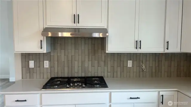Picture is of similar home - Cabinet color will be grey and different tile.