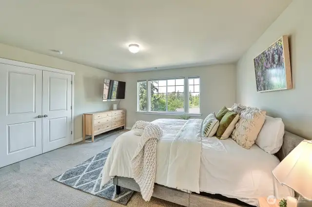 Located at the top of the stairs, you enter the primary suite through lovely double doors.