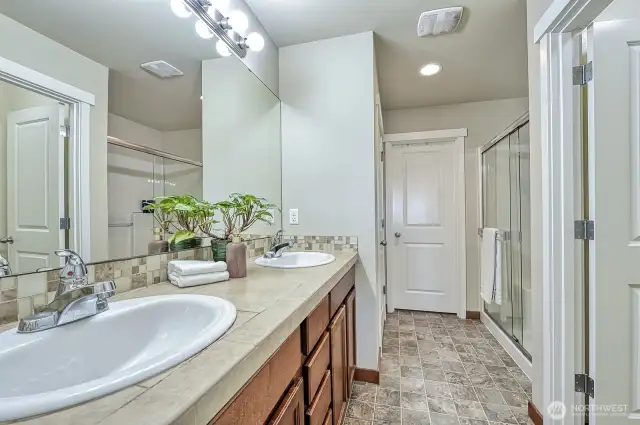 This is the bathroom in the primary suite. The water closet is to the right and the walk-in closet is straight ahead.