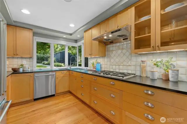 A warm and inviting kitchen. Plenty of counter space. A gas range. Generous cabinet space with under cabinet lighting, 2 sinks and updated appliances.
