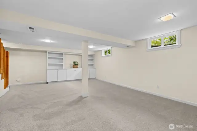 Basement area with built-in cabinets.
