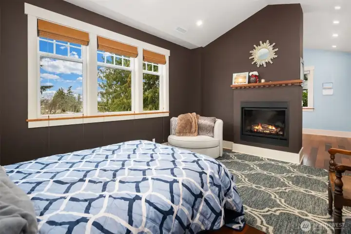 Primary bedroom with wrap around gas fireplace