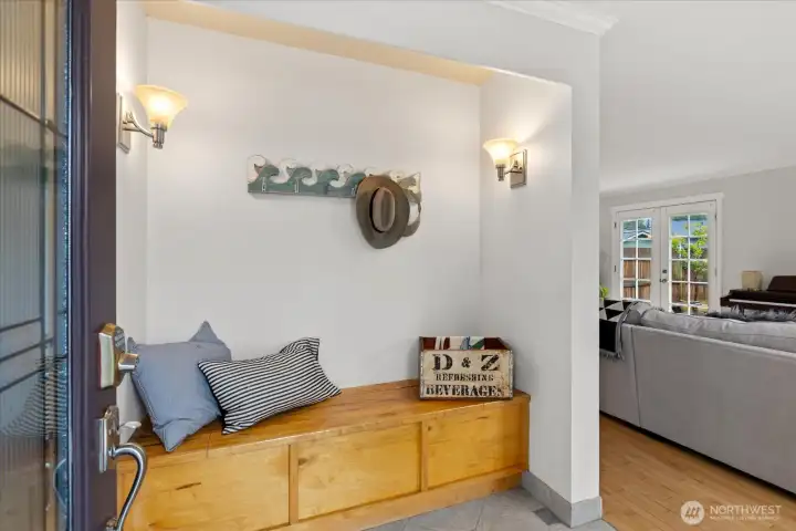Come in!  Make yourself cozy while taking off your shoes and coats.  Built in bench features extra storage.