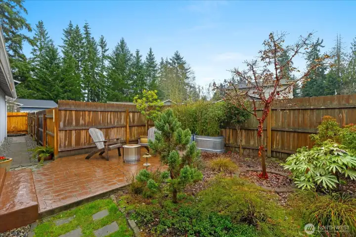 Private garden patio.  Steps lead to french doors in the living room.  Path on the left leads to the back of the house.