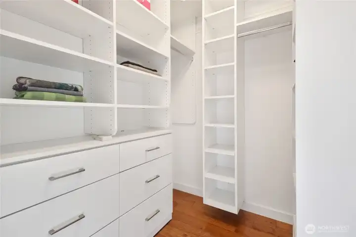 Another large walk-in closet with organizer is located in the primary bedroom.