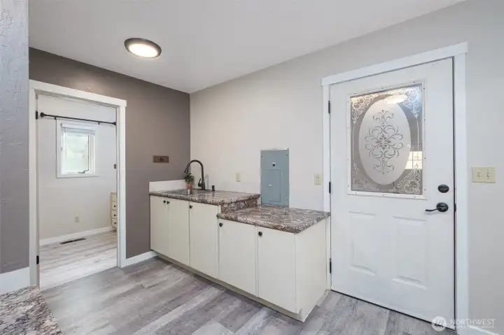 Main Floor Utility Room Leads to Mud Room with Workshop and Walk-in Refrigeration Room