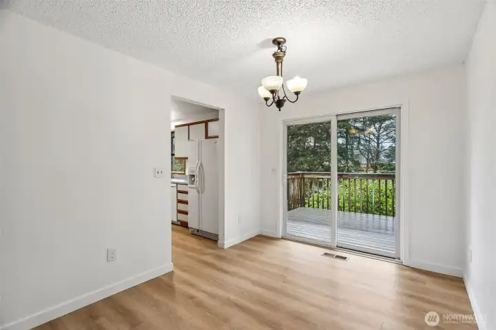 Dining room with back deck accessible via slider. Deck and yard are west facing and great sun