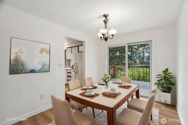 Dining room with back deck accessible via slider. Deck and yard are west facing and great sun