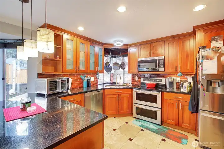 Beautiful island kitchen with granite counters and tile floors