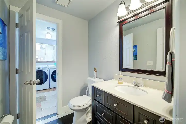 Half bath on main floor leads to utility room and garage; tile floors!