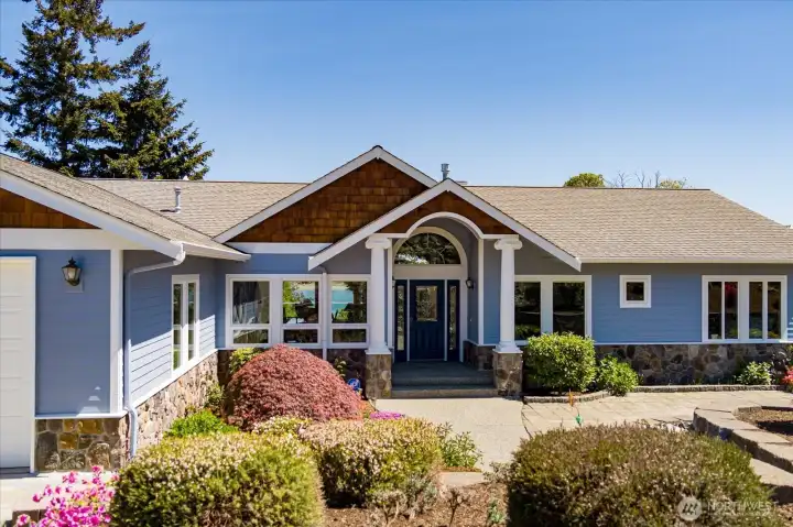 Pretty gardens and soothing water feature usher you in to this stunning residence.