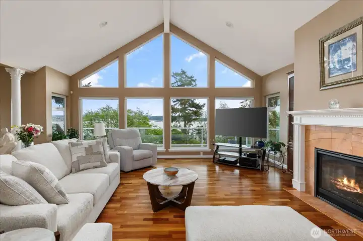 This dreamy living room, with its vaulted ceiling and wall of windows, sets the stage for maximizing the views!