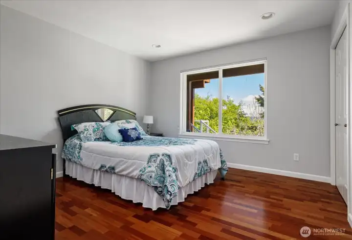 To the right of the living room, is the first bedroom.