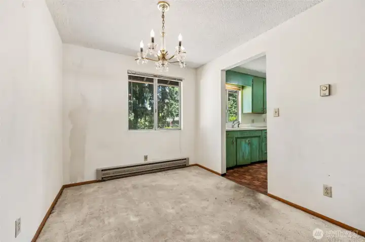 Here's a closer look at one of this home's fun vintage details: the original dining room chandelier hanging proudly at center stage. It's exactly the kind of feature that mid-century enthusiasts get excited about and a reminder of the home's authentic 1960s roots. From this angle, you can also see the convenient connection to the kitchen, creating an easy flow for meals, holiday gatherings and everyday living. Another often-overlooked benefit of this era of construction is the electric baseboard heating system, which allows individual room-by-room temperature control. Prefer your dining room cooler while keeping the living room cozy? You've got options. Here's a closer look at one of this home's fun vintage details: the original dining room chandelier hanging proudly at center stage. It's exactly the kind of feature that mid-century enthusiasts get excited about and a reminder of the home's authentic 1960s roots. From this angle, you can also see the convenient connection to the kitchen, creating an easy flow for meals, holiday gatherings and everyday living. Another often-overlooked benefit of this era of construction is the electric baseboard heating system, which allows individual room-by-room temperature control. Prefer your dining room cooler while keeping the living room cozy? You've got options.
