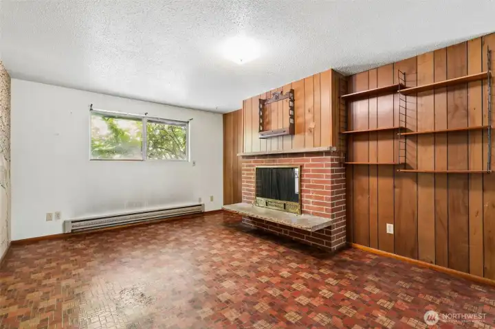 The entire fireplace wall is wrapped in the same original multi-width wood paneling found throughout the home, creating a warm backdrop for the handsome brick fireplace. A raised hearth with natural stone accents, classic mantel and vintage brass-and-chain fireplace screen all contribute to the feeling that you've stepped into a wonderfully preserved time capsule. For buyers who love original architecture and design, there's a lot here to appreciate. For investors and flippers, it's a chance to decide how much of this vintage personality stays for the next generation. The entire fireplace wall is wrapped in the same original multi-width wood paneling found throughout the home, creating a warm backdrop for the handsome brick fireplace. A raised hearth with natural stone accents, classic mantel and vintage brass-and-chain fireplace screen all contribute to the feeling that you've stepped into a wonderfully preserved time capsule. For buyers who love original architecture and design, there's a lot here to appreciate. For investors and flippers, it's a chance to decide how much of this vintage personality stays for the next generation.
