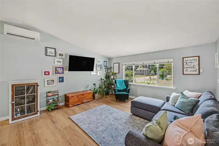 Spacious living room enhanced by an expansive window and open layout.