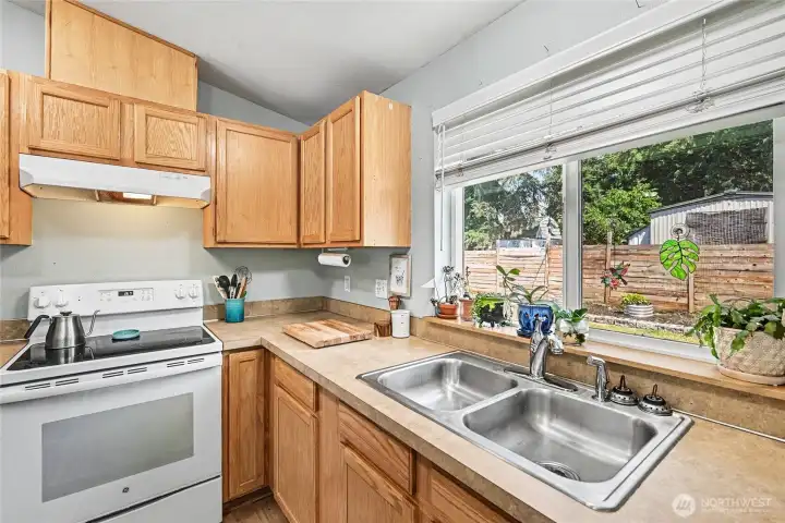 Large kitchen window offers pleasant views of the backyard.