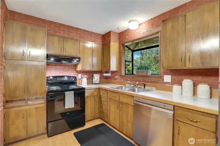 The kitchen includes a full set of appliances: the oven/range, a newer dishwasher, and a refrigerator/freezer. The kitchen includes a full set of appliances: the oven/range, a newer dishwasher, and a refrigerator/freezer.