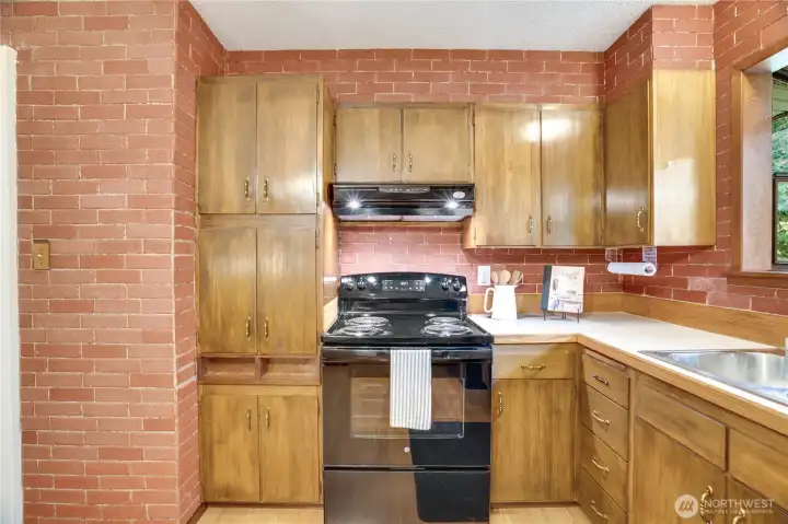This kitchen is open to the dining area and front living room with lots of cabinet storage. This kitchen is open to the dining area and front living room with lots of cabinet storage.