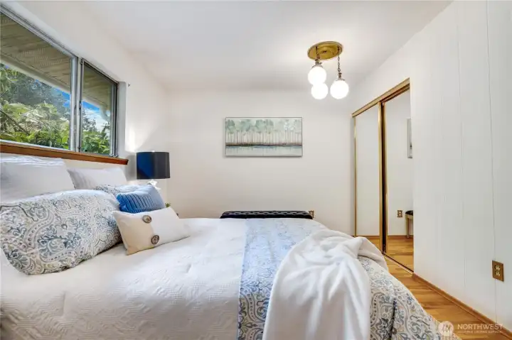 Each bedroom has oak floors, a closet, and a window to the yard with trees and shrubs for privacy. Each bedroom has oak floors, a closet, and a window to the yard with trees and shrubs for privacy.