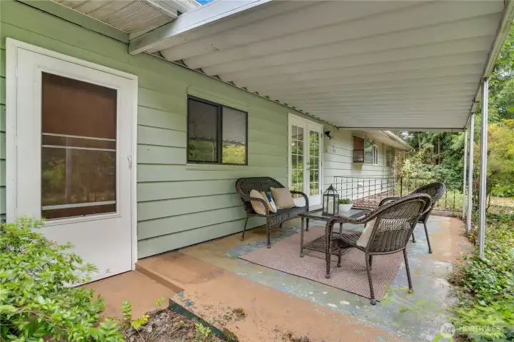 If you take the back door out from the bonus room, you reach the covered patio. A gate on this side of the house opens to the carport area and driveway. If you take the back door out from the bonus room, you reach the covered patio. A gate on this side of the house opens to the carport area and driveway.