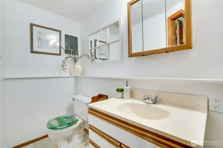Open the door to the garage to reach this private half bath. Open the door to the garage to reach this private half bath.